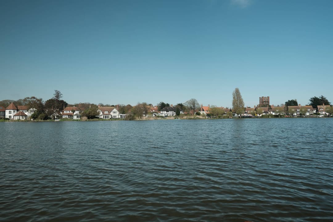 body of water with a small village in the background